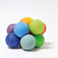 A cluster of wooden circular beads in bright rainbow colours