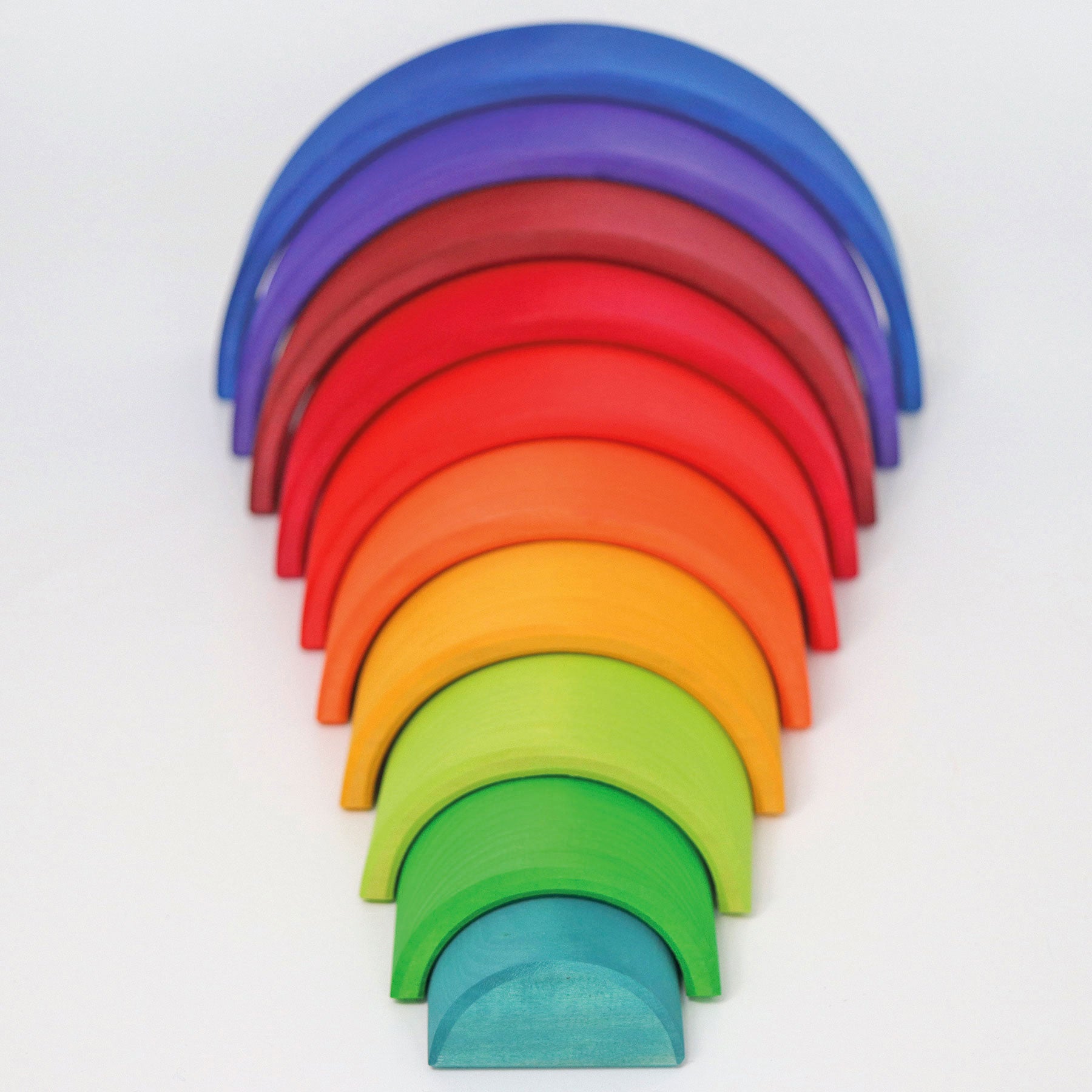A wooden rainbow is arranged so that the arches are spread out and form a tunnel